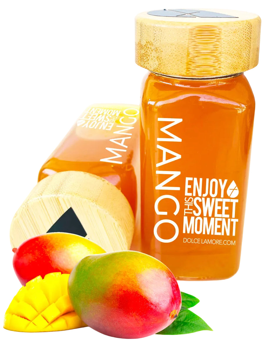Mango flavored puree in a glass bottle on a white background