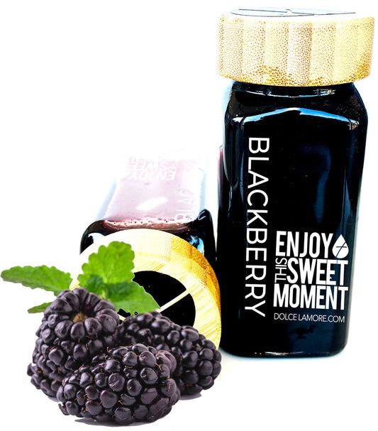 Bottle of Blackberry Dolce L'Amore with blackberries and a gold cap on a white background