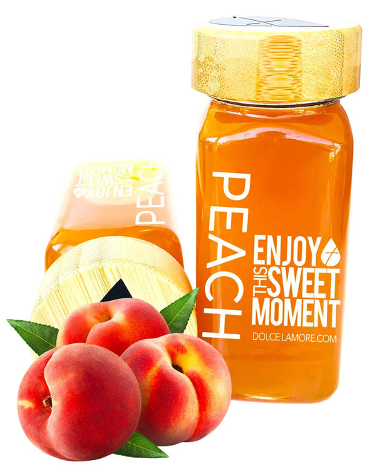 Peach puree in a glass bottle with peach flavor and packaging, surrounded by peaches on a white background.